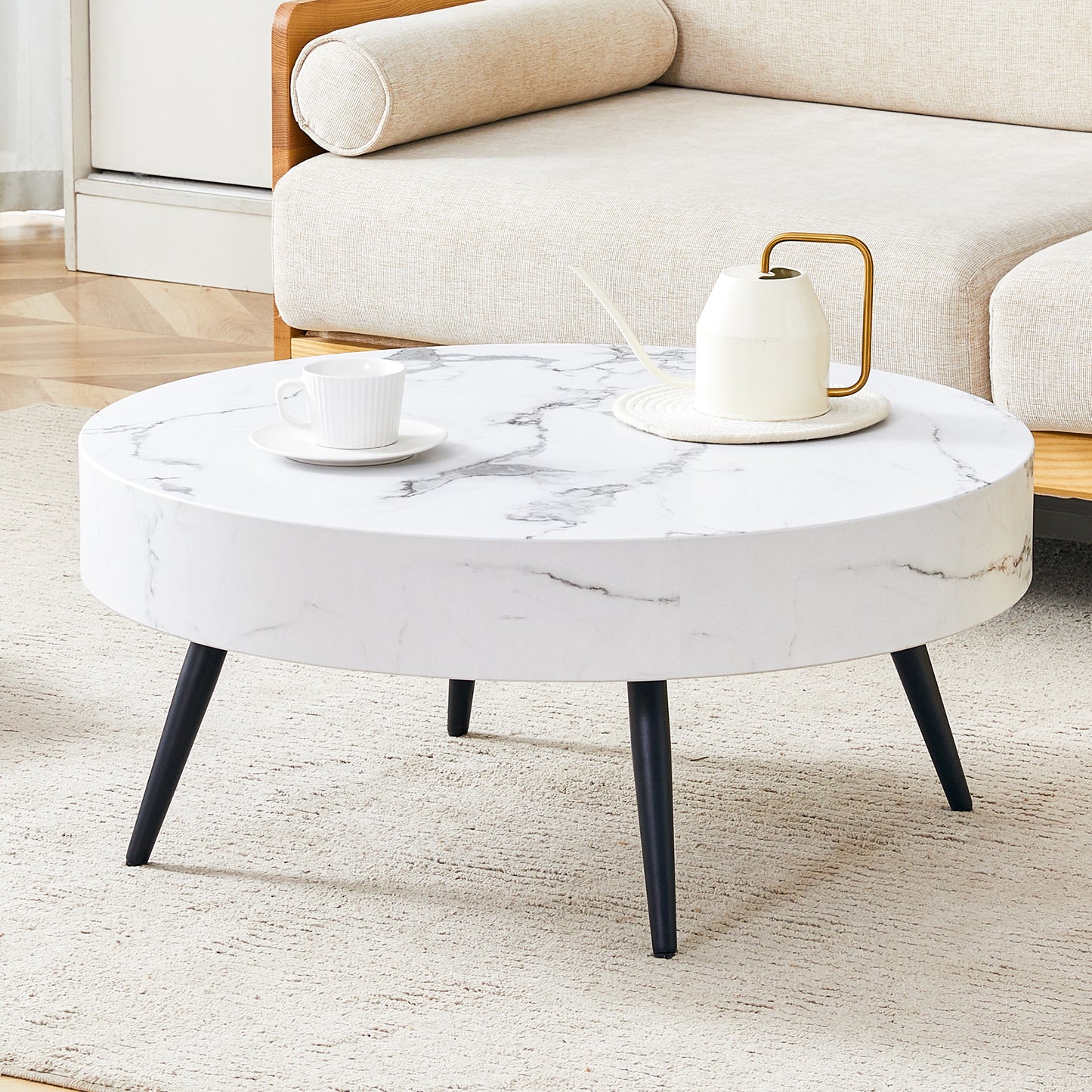 Modern 31.5' Round Coffee Table with White Marble-Patterned MDF and Black Metal Legs, Adjustable Feet.The three black conical table legs are distributed in a golden triangle.