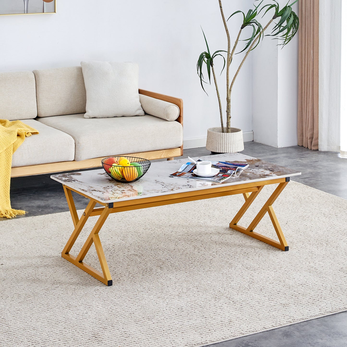 A coffee table is made of rock slab material, with a natural and smooth marble pattern on the surface, which complements the modern design of the golden metal legs and adds a touch of fashion.47*23.6